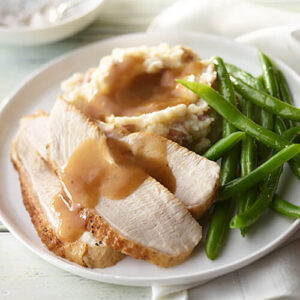 beautifully plated turkey breast accompanied by traditional sides, ideal for a cozy meal for two